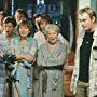 The women of Knapely (left to right, front row: Lesley Staples, Angela Curran, Julie Walters, Rosalind March, Penelope Wilton, Annette Crosbie. left to right, back row: Janet Howd, Celia Imrie, Georgie Glen, Linda Bassett) prepare to bare all for their photographer, Lawrence (Philip Glenister, right).