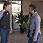 Director, William H Macy, and writer, Lance Krall, discuss a scene on the set of "The Layover"