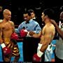 Vince and Cesar get instruction from the ref (Darrel Foster), flanked by their trainers, played by Eloy Casados (left) and Henry G. Sanders (right). Famed ring announcer, Michael Buffer stands behind the ref. 