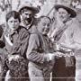 John E. Brennan, Pat Hartigan, and Ruth Roland in She Would Be a Cowboy (1915)