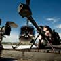 Avi Cohen (left) Directs with a camera in Hand. Gabriella Kuti (right) wheedling the Barrett 50 caliber sniper rifle, for GT Radials two Hours To Vegas 